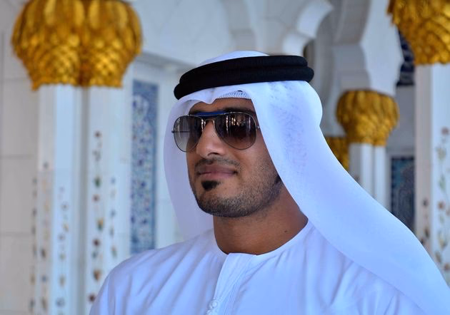 Should women wear traditional dress in Abu Dhabi?